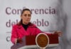 President Sheinbaum gestures while speaking from the podium of her morning press conference