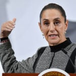 President Sheinbaum gestures as she speaks from behind her press conference podium