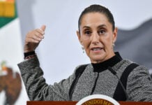 President Sheinbaum gestures as she speaks from behind her press conference podium