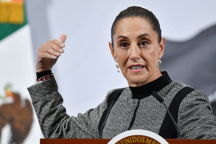 President Sheinbaum gestures as she speaks from behind her press conference podium
