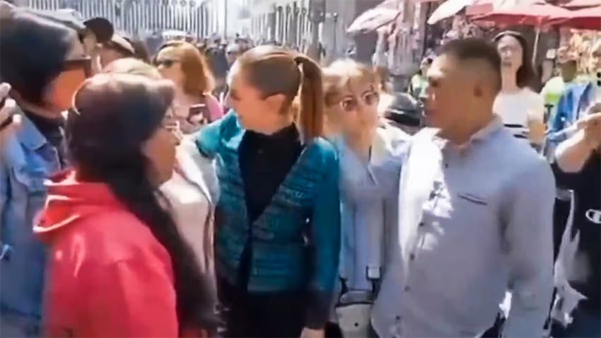 A blurry image shows President Sheinbaum in a crowd of people, next to a man in a blue shirt