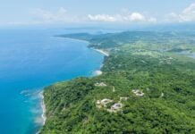 Aerial view of lo de marcos, nayarit, mexico, showcasing the stunning coastline, crystal-clear turquoise waters, sandy beach, and lush green vegetation