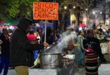 a vendor serving punch in the cold