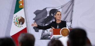 President Sheinbaum gestures from the podium of her morning press conference