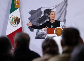 President Sheinbaum gestures from the podium of her morning press conference