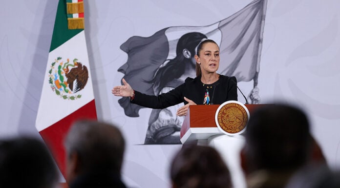 President Sheinbaum gestures from the podium of her morning press conference