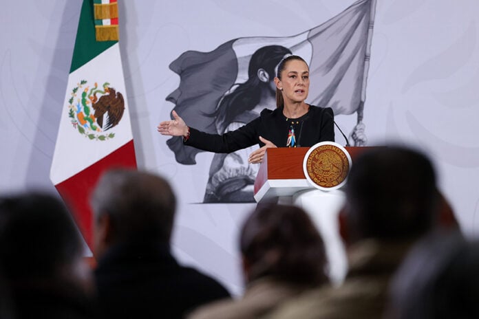 President Sheinbaum gestures from the podium of her morning press conference