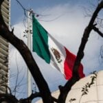 A Mexican flag flies near downtown Mexico City