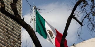 A Mexican flag flies near downtown Mexico City