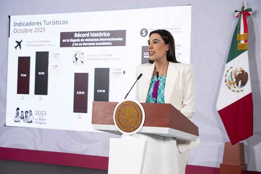 Tourism Minister Josefina Rodríguez shares a slide showing tourism data at a press conference