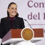 Sheinbaum smiles from her morning press conference podium