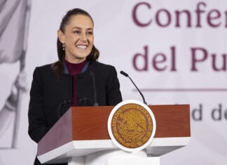 Sheinbaum smiles from her morning press conference podium