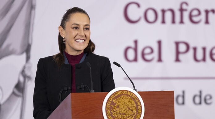 Sheinbaum smiles from her morning press conference podium