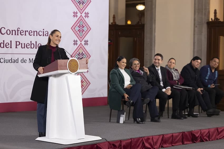 Sheinbaum at her press conference podium next to several seated administration officials