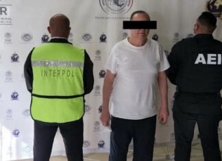 A man in a white shirt under arrest