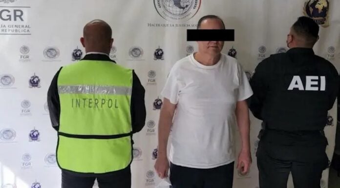 A man in a white shirt under arrest