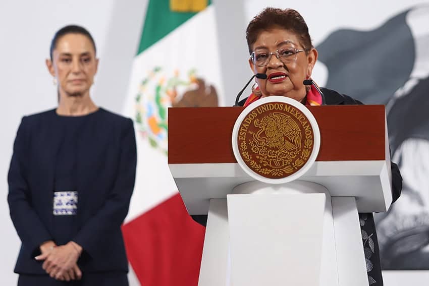 President Sheinbaum stands behind Ernestina Godoy at a press conference