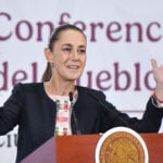President Sheinbaum gestures from behind the podium of her morning press conference