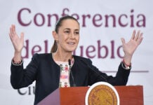 President Sheinbaum gestures from behind the podium of her morning press conference