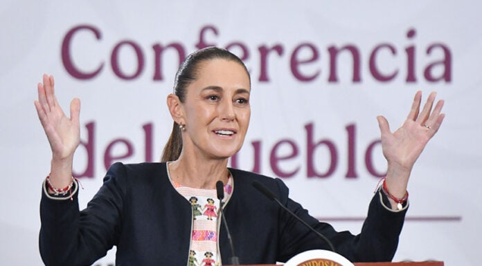 President Sheinbaum gestures from behind the podium of her morning press conference