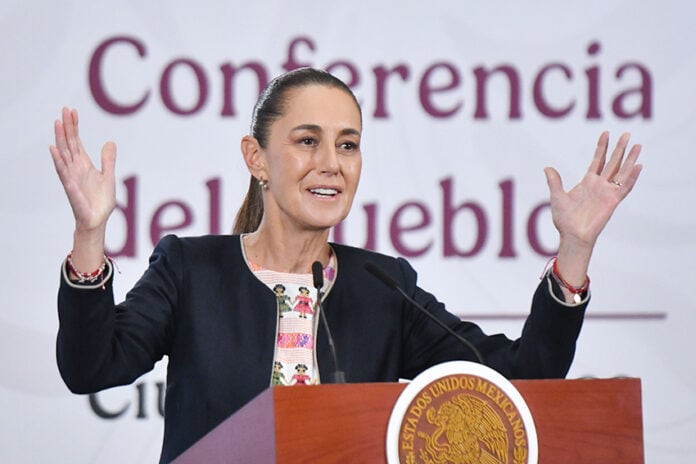 President Sheinbaum gestures from behind the podium of her morning press conference