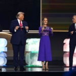 President Sheinbaum on stage next to Trump and Carney, holding a paper reading Mexico