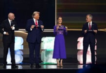 President Sheinbaum on stage next to Trump and Carney, holding a paper reading Mexico