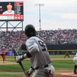 A Yankee batter swings at a baseball thrown by the Mexico City Diablos Rojos pitcher in Alfredo Harp Helú Stadium