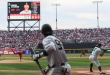 A Yankee batter swings at a baseball thrown by the Mexico City Diablos Rojos pitcher in Alfredo Harp Helú Stadium