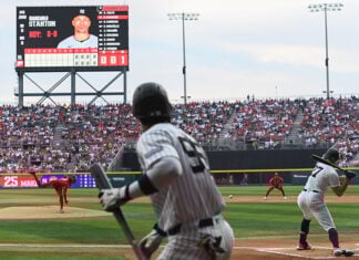 A Yankee batter swings at a baseball thrown by the Mexico City Diablos Rojos pitcher in Alfredo Harp Helú Stadium