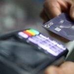 a person using a credit card at a terminal