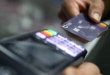 a person using a credit card at a terminal
