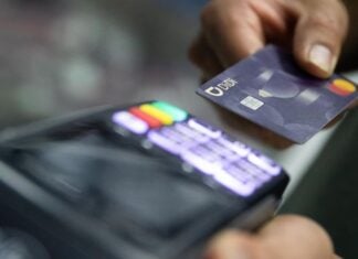 a person using a credit card at a terminal