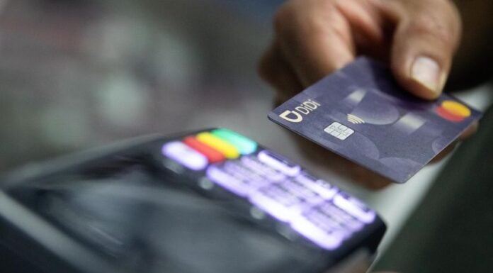 a person using a credit card at a terminal