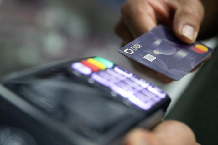 a person using a credit card at a terminal