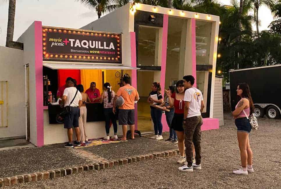 Mexicans stand in line in Puerto Vallarta at a pink and white ticket booth for the Movie Picnic, an outdoor film series that is one of the most anticipated Puerto Vallarta events of the year.