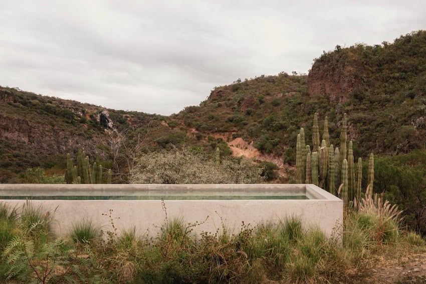 A swimming pool in front of mountains