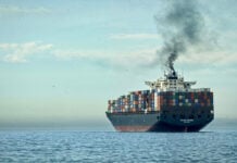 A plume of smoke rises from a cargo tanker at sea