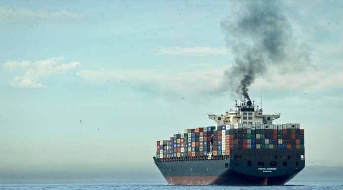 A plume of smoke rises from a cargo tanker at sea