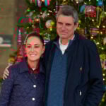 President Sheinbaum and her husband in front of a Christmas tree