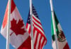 Flags of United States, Mexico, Canada flying together, concept of new NAFTA agreement now known as USMCA in the U.S., CUSMA in Canada or T-MEC in Mexico.