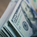 Cash counting machine counts hundred dollar bills