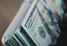 Cash counting machine counts hundred dollar bills