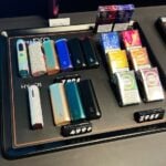 Kyiv, Ukraine - February 04, 2025: Selection of vaping devices, flavored pods, and accessories on a store counter display