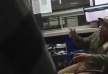 A customs agent gestures in a blurry video screenshot