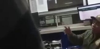 A customs agent gestures in a blurry video screenshot