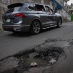a car avoiding a pothole on a street in Mexico