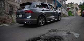 a car avoiding a pothole on a street in Mexico