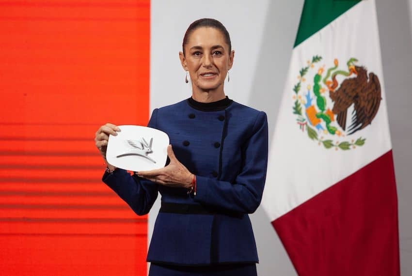 Sheinbaum with Olinia logo