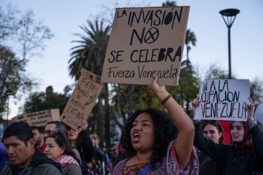 In San Cristobal de las Casas, Chiapas, a protester holds a sign reading: "Invasion is not celebrated. Strength, Venezuela."